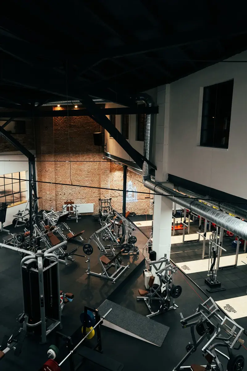 MarvelGym – industriální prostory nové pobočky: cihlové zdivo, ocelové nosníky a rekuperační potrubí